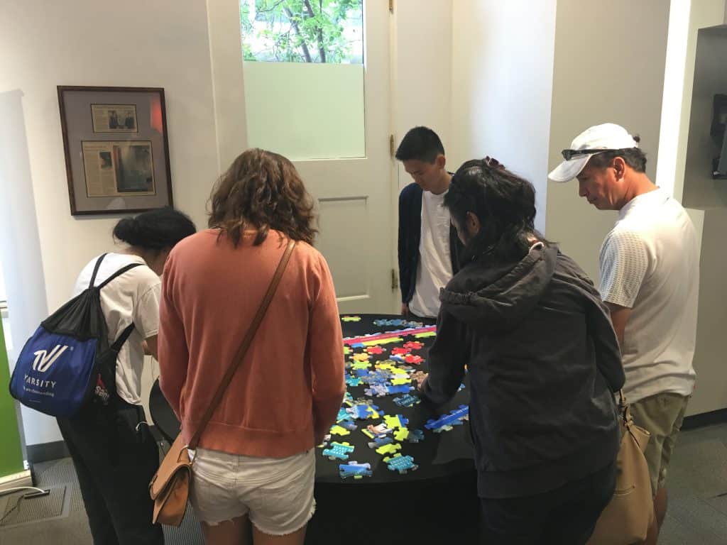 museum patrons assembling custom museum puzzle