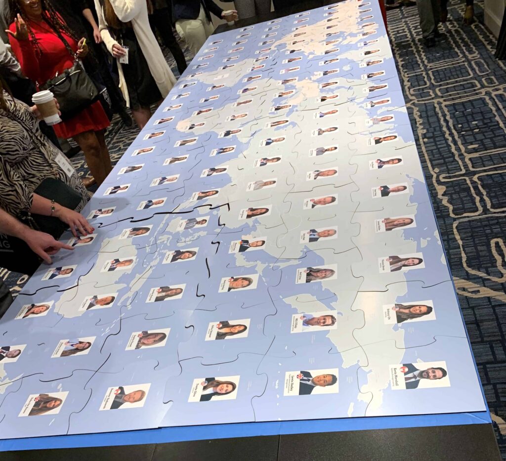 giant custom puzzle with different employee images on each puzzle piece