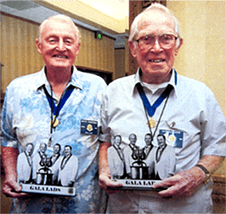 barbershop photo statuettes held by honored guest